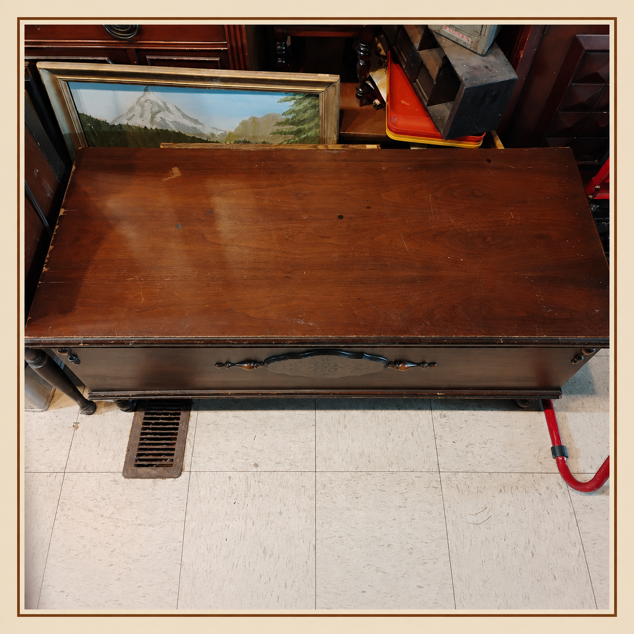 Vintage Lane cedar chest with decorative front panel and wood top showing visible wear consistent with age and use.