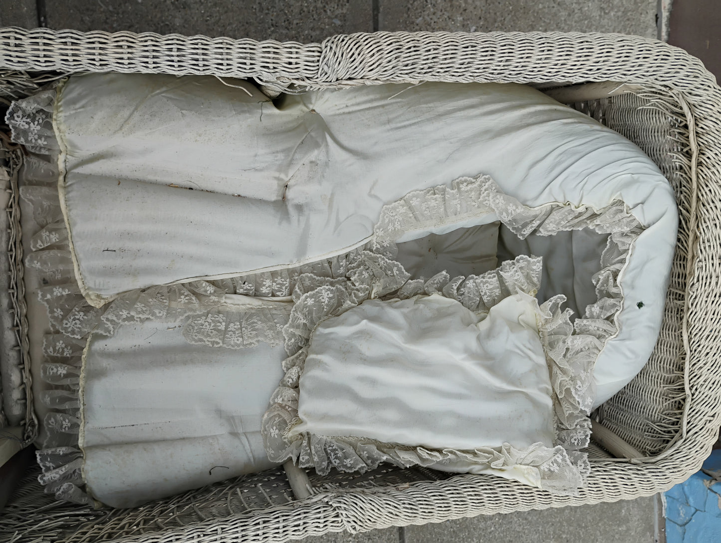 White lace fabric inside an antique baby buggy interior. 
